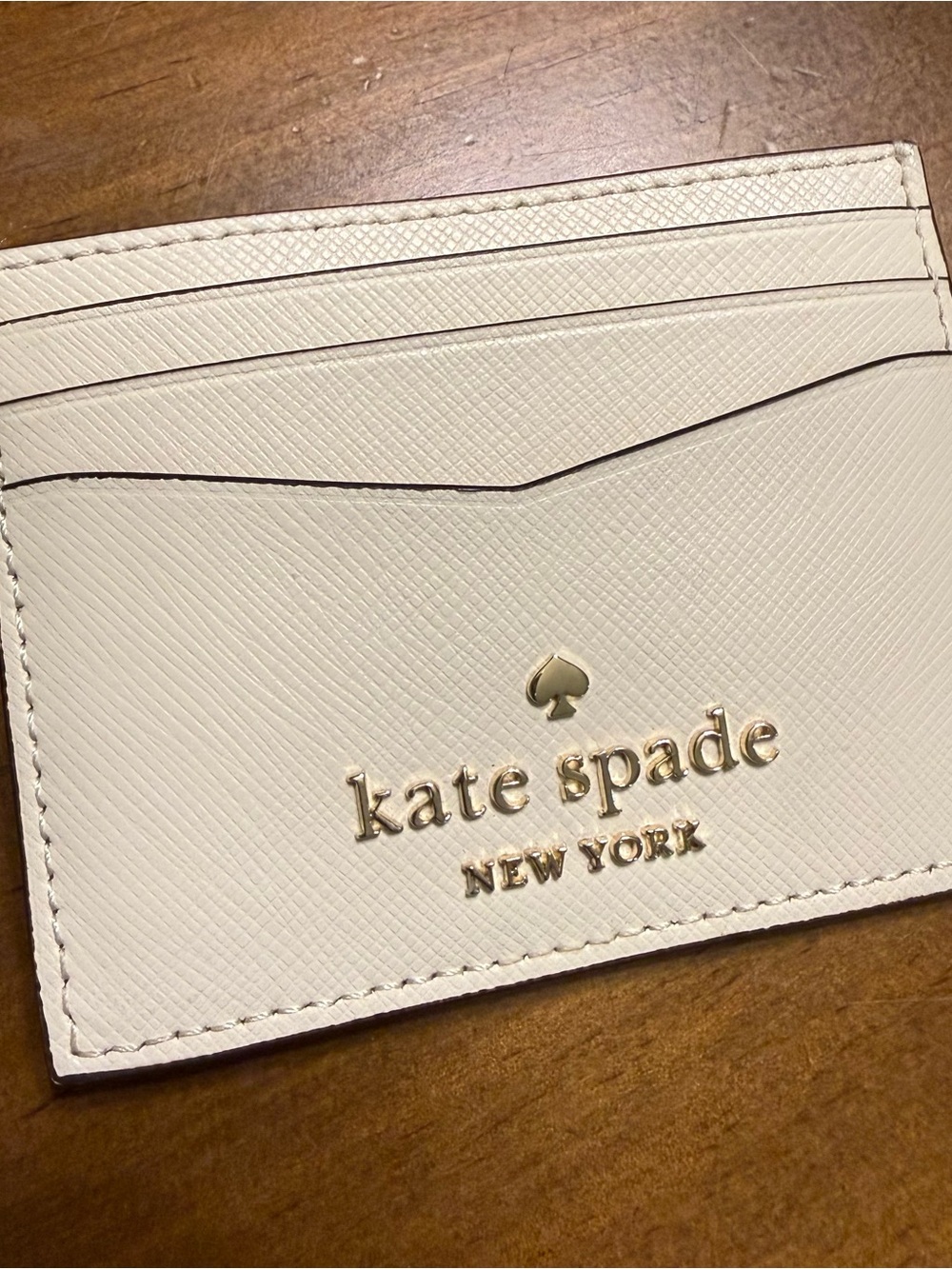 kate spade cream card case with gold logo